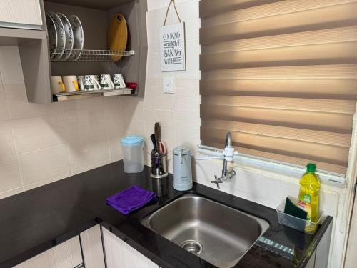 a kitchen counter with a sink in a kitchen at SPICE Skyview Luxe Tunas 3B2B in Relau