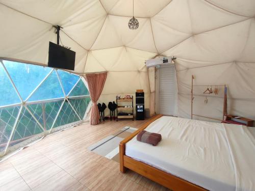 a bedroom in a tent with a bed in it at Glamping Dome Kusumanagara 2 in Bandung