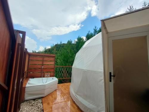 a bathroom with a toilet in a dome tent at Glamping Dome Kusumanagara 2 in Bandung