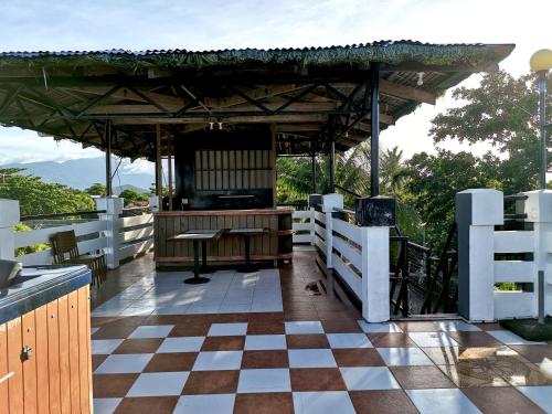 a pavilion with a table on a checkered floor at Villaroman Inn in Baler