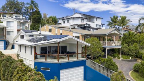 an aerial view of a house with a blue roof at For - Resters in Wamberal