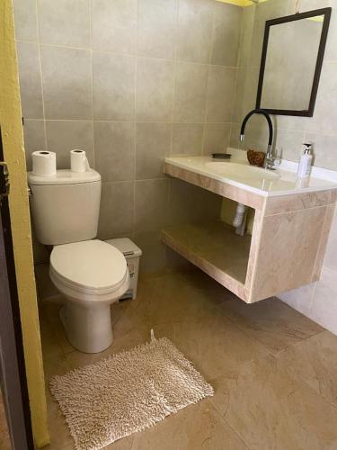 a bathroom with a toilet and a sink at Una Mirada al Atardecer in Pedregoso