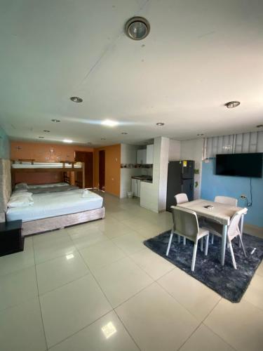 a bedroom with a bed and a table and chairs at Posada Dakema in Cartagena de Indias
