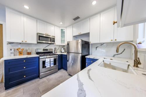 a kitchen with blue cabinets and a stainless steel refrigerator at Lovely 2bedroom next to Santa Monica college in Los Angeles