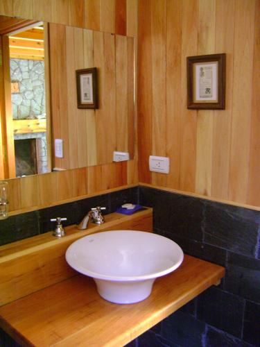 a bathroom with a white sink and a mirror at El Recodo in San Martín de los Andes