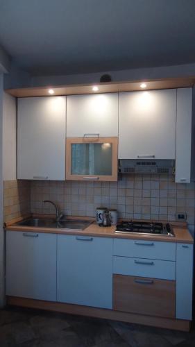 a kitchen with white cabinets and a sink at La Federiga in Florence