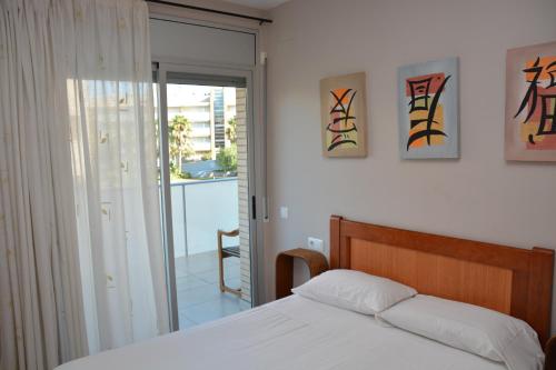a bedroom with a bed and some paintings on the wall at Saval Spa Aqquaria Family Complex in Salou