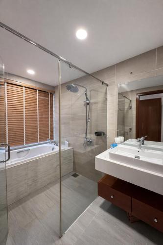 a bathroom with a tub and a sink at Luxury villa Phu Quoc in Phú Quốc