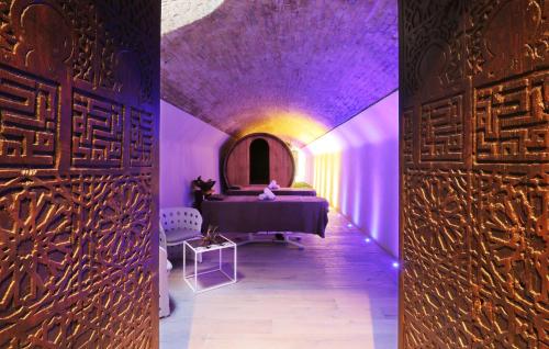 a room with a purple ceiling and a room with a table at Relais San Maurizio in Santo Stefano Belbo