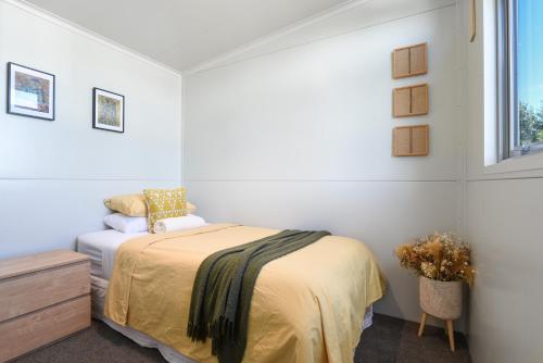 a bedroom with a bed and a window at Ngongotahā Getaway in Rotorua