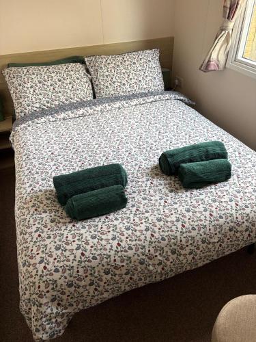 a bed with two green pillows on it at Sunflower Retreat in Cresswell