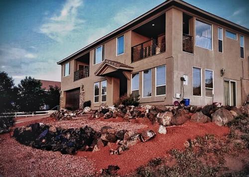 a house with a bunch of rocks in front of it at The Zion House - Affordable Bedrooms in Hurricane