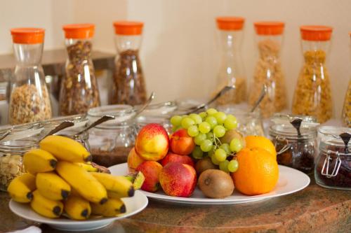 a table with two plates of fruit on it at Romantik Hotel Schubert in Lauterbach