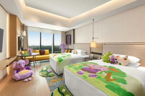 a bedroom with two beds and a living room at Renaissance Beijing Haidian Hotel in Beijing