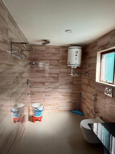 a bathroom with a shower and a toilet at Mughal resort pahalgam in Pahalgām