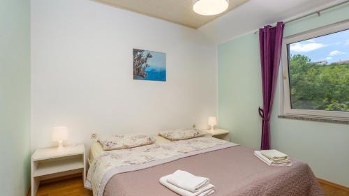 a white bedroom with a bed and a window at Villa Risika 2 with pool island Krk by Villas Guid in Risika