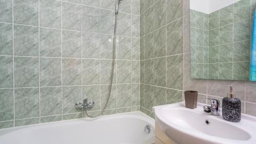 a bathroom with a shower and a sink and a tub at Villa Risika 2 with pool island Krk by Villas Guid in Risika