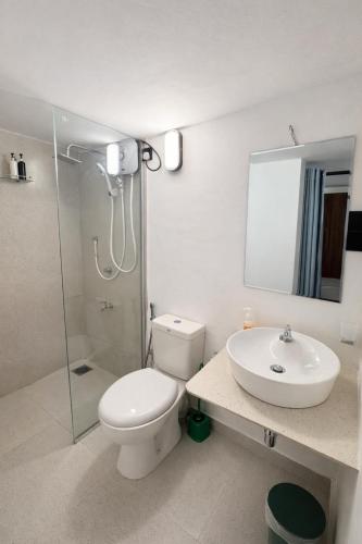 a bathroom with a toilet and a sink and a shower at Stara Weligama in Weligama