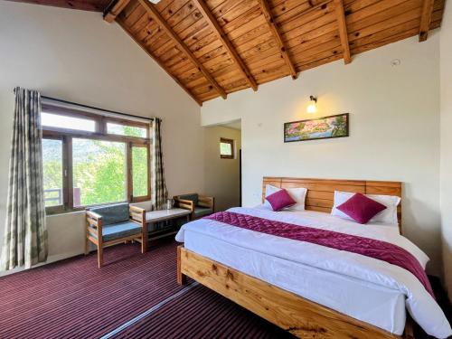 a bedroom with a large bed and a window at Oak Essence in Mukteshwar