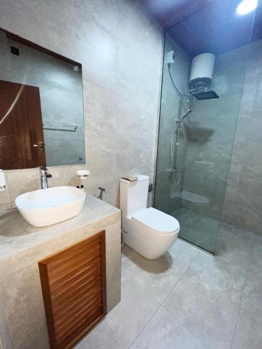 a bathroom with a toilet and a sink and a shower at The Chill Heights Ramboda in Ramboda