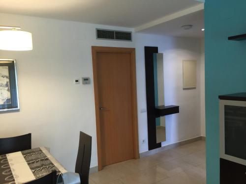 a room with a door and a room with a table at Saval Spa Aqquaria Family Complex in Salou
