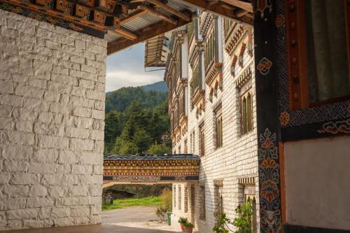 an archway of a building with a train passing through it at Samyae Resort in Jakar