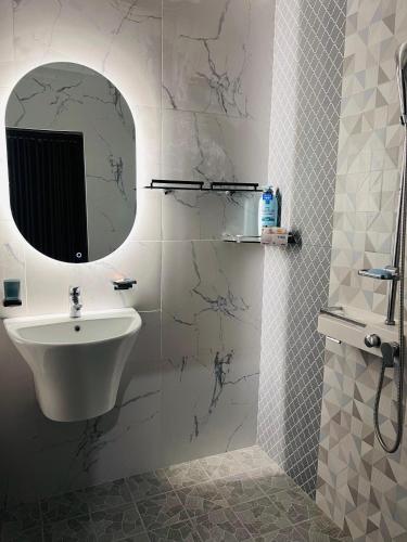 a bathroom with a sink and a mirror at K won Villa in Busse