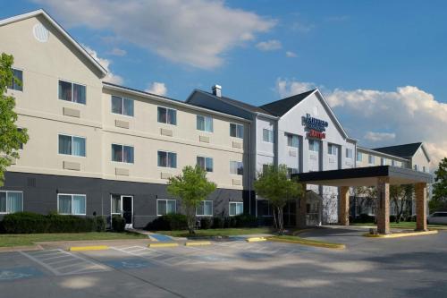 an exterior view of a hotel with a parking lot at Fairfield Inn & Suites Dallas Park Central in Dallas