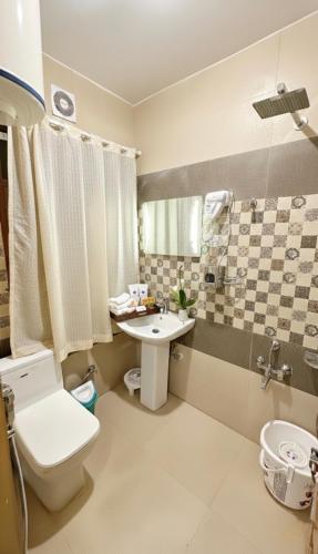 a bathroom with a toilet and a sink at Faizzy residency in Srinagar