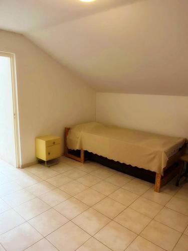 a small bedroom with a bed and a night stand at 4 Persoons Woning met Zwembad. Rustig gelegen. in Figueira e Barros