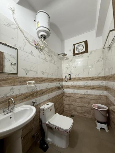 a bathroom with a toilet and a sink at Bunkyard rishikesh in Rishīkesh