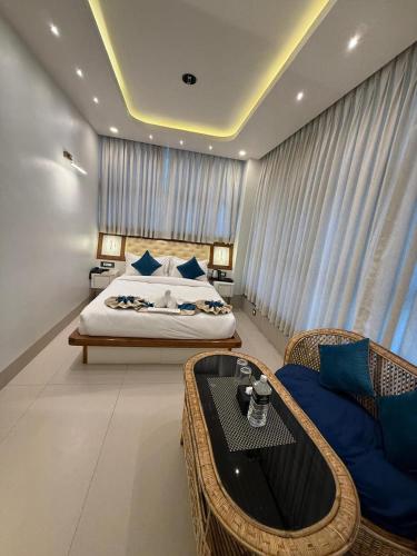 a bedroom with a bed and a table and a couch at The Hotel Art 8 in Pātan