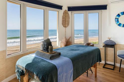 a bedroom with a bed and a view of the beach at Marriott's Marbella Beach Resort in Marbella