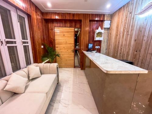 a living room with a couch and a bar at Mount kirola stay in Bhowāli