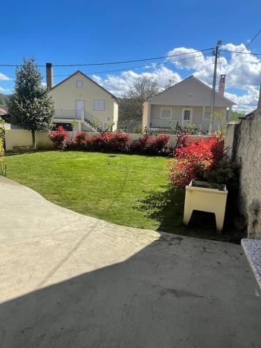 a house with a yard with a bench in the grass at O Palheiro in Bragança