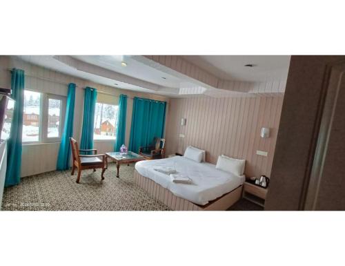a hotel room with a bed and a table at Hotel Alpine Ridge, Gulmarg in Gulmarg