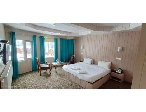a hotel room with a bed and a table at Hotel Alpine Ridge, Gulmarg in Gulmarg