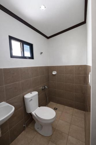 a bathroom with a toilet and a sink at Tribo Zamani in General Luna