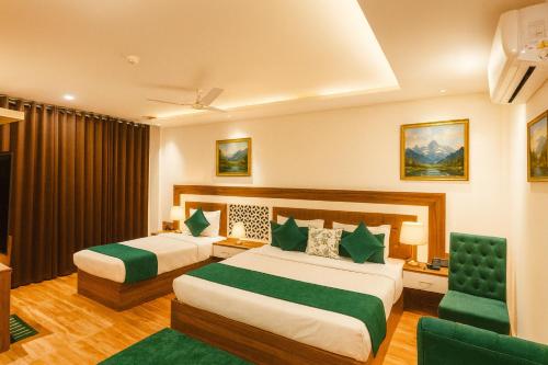 a hotel room with two beds and a chair at The W H I T E Amritsar in Amritsar