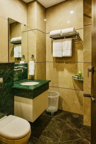a bathroom with a toilet and a sink at The W H I T E Amritsar in Amritsar