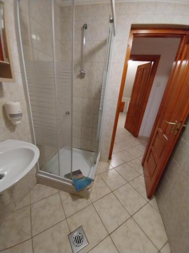 a shower with a glass door in a bathroom at Mohos Vendégfogadó in Kelemér