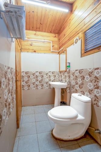 a bathroom with a toilet and a sink at Beach Walk Resort Walk In Morjim Beach Goa in Morjim