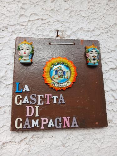 a sign on the side of a building at La Costa del Pavone in Carini