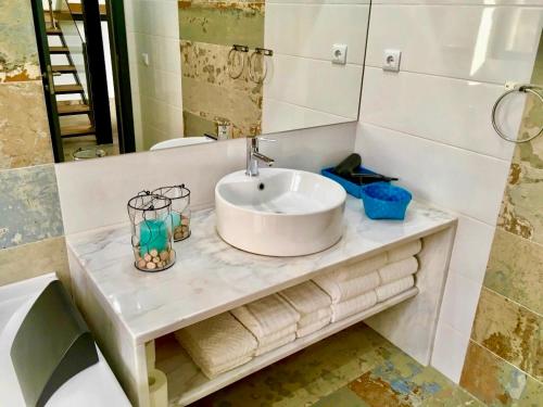a bathroom with a sink and a mirror at Private Hot Tub All Year Round - 25 min Lisbon in Setúbal