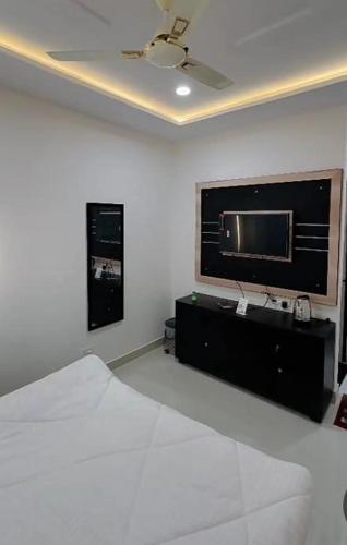 a bedroom with a bed and a flat screen tv at Zoz jhodpur in Jodhpur