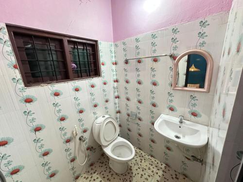 a bathroom with a toilet and a sink at Richard's Homestay 7 BHK in Thiruvalla