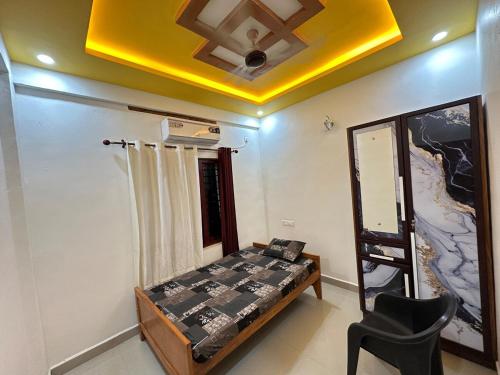 a room with a bed and a ceiling fan at Richard's Homestay 7 BHK in Thiruvalla