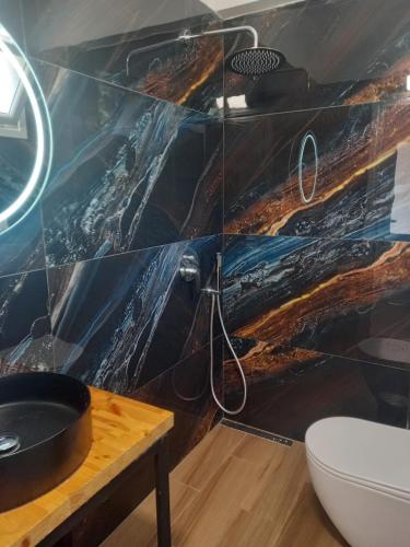 a bathroom with a sink and a toilet at Villa Klaus in Lukovë