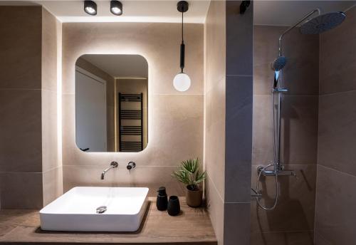 a bathroom with a sink and a mirror at The Alley in Litochoro