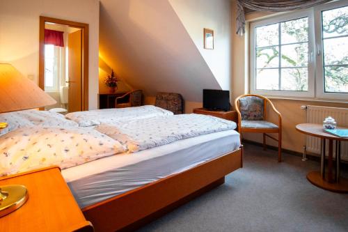 a bedroom with a large bed and a window at Pension An der Bleiche in Wustrau